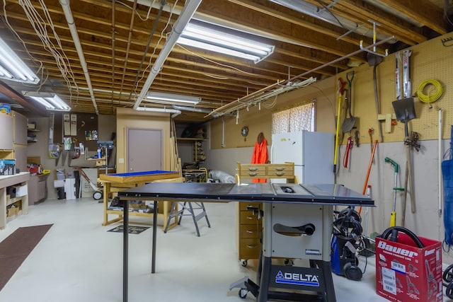 basement featuring freestanding refrigerator