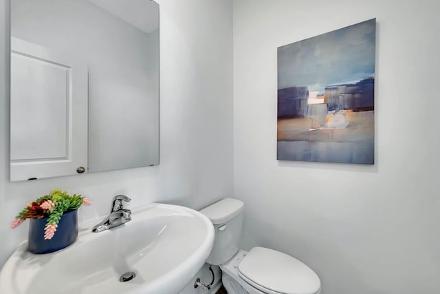 bathroom featuring toilet and a sink