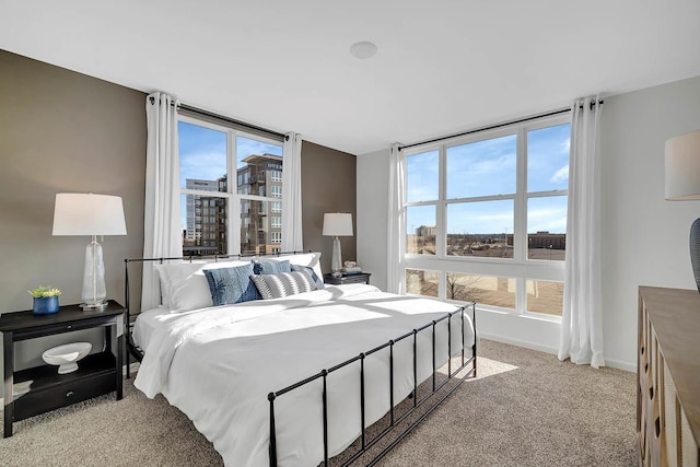 bedroom featuring baseboards and light colored carpet