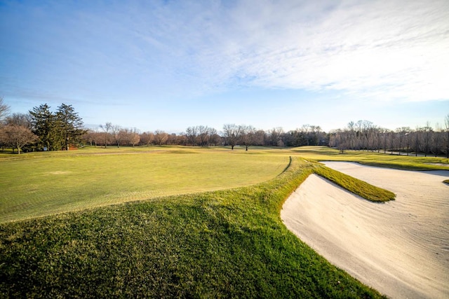 view of home's community with a lawn and golf course view