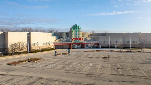 view of building exterior with uncovered parking