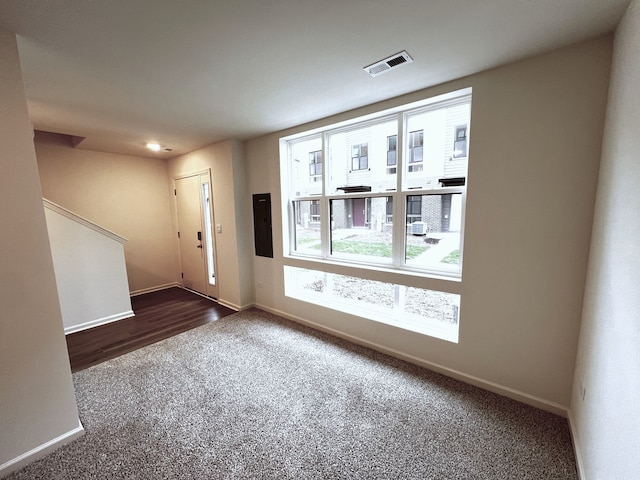 entryway featuring visible vents, carpet, and baseboards