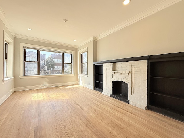 unfurnished living room with baseboards, wood finished floors, and crown molding