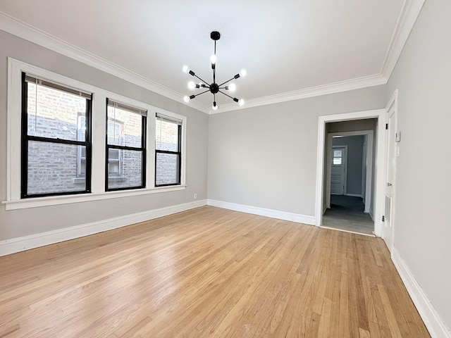 unfurnished room featuring baseboards, an inviting chandelier, ornamental molding, and light wood finished floors