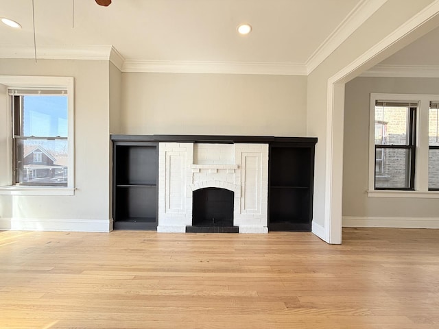 unfurnished living room with recessed lighting, crown molding, baseboards, and wood finished floors