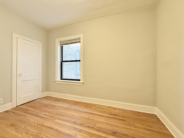 unfurnished room featuring light wood-style flooring and baseboards