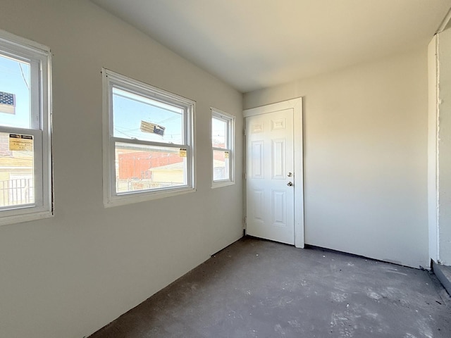 unfurnished bedroom featuring concrete flooring