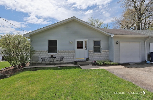 17825 W Cheyenne Ct, Grayslake, IL 60030 - view of front facade with brick siding, an attached garage, a front yard, and driveway