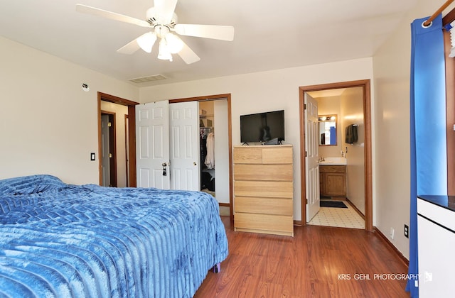 17825 W Cheyenne Ct, Grayslake, IL 60030 - bedroom featuring wood finished floors, a closet, a sink, baseboards, and a ceiling fan