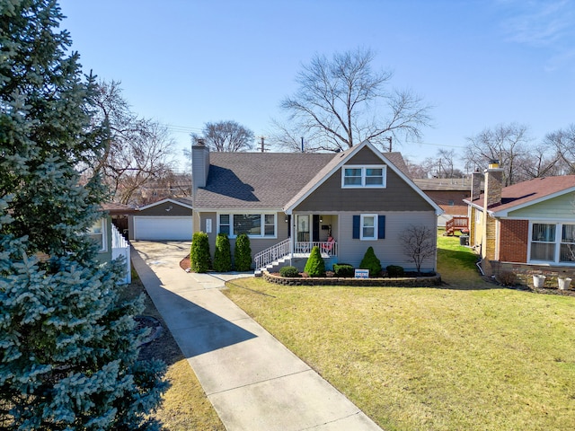 view of front of house with an outbuilding, a front yard, a shingled roof, a chimney, and a garage