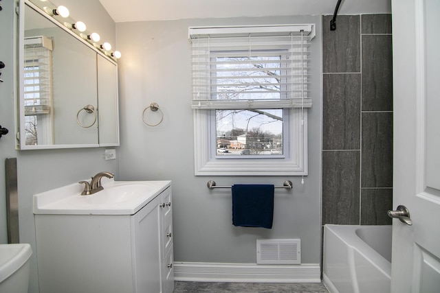 bathroom featuring visible vents, baseboards, toilet, and vanity