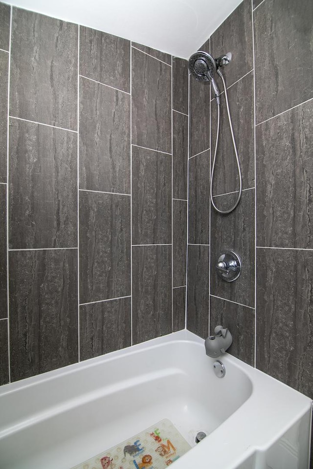 bathroom with bathing tub / shower combination