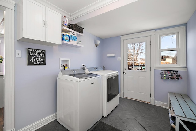 laundry room featuring crown molding, cabinet space, baseboards, and washing machine and clothes dryer