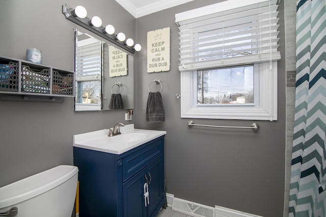 full bathroom featuring vanity, baseboards, visible vents, ornamental molding, and toilet