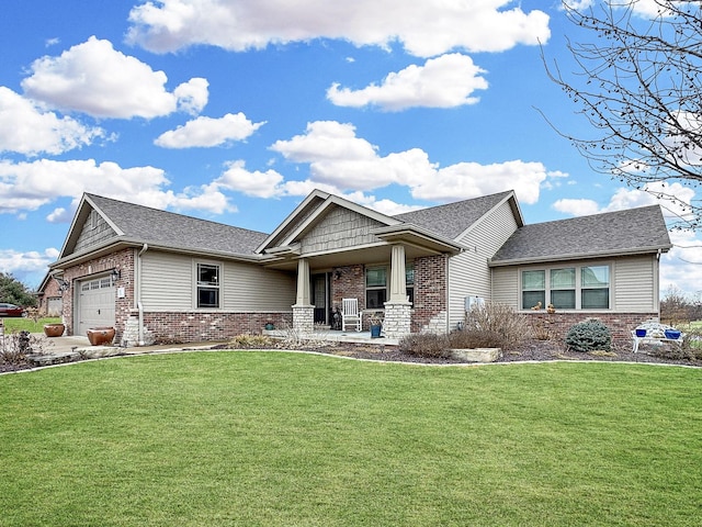 craftsman house featuring brick siding, a front yard, a garage, and a shingled roof