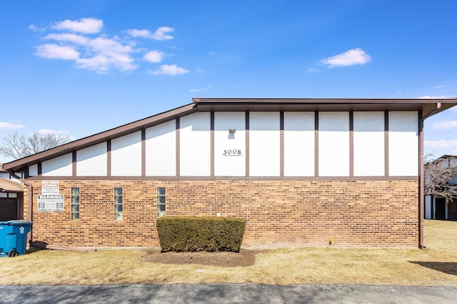 view of side of property with brick siding