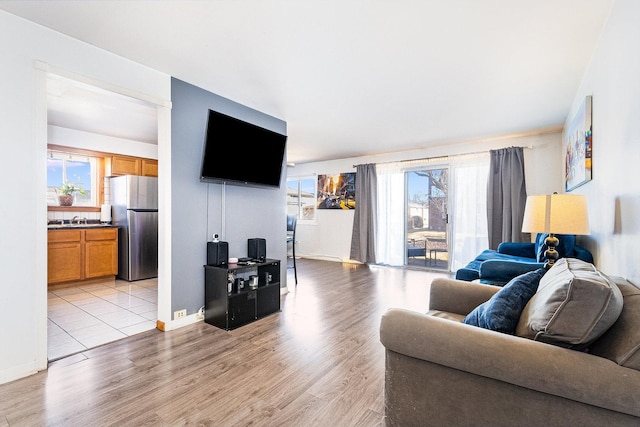 living room featuring baseboards and light wood-type flooring