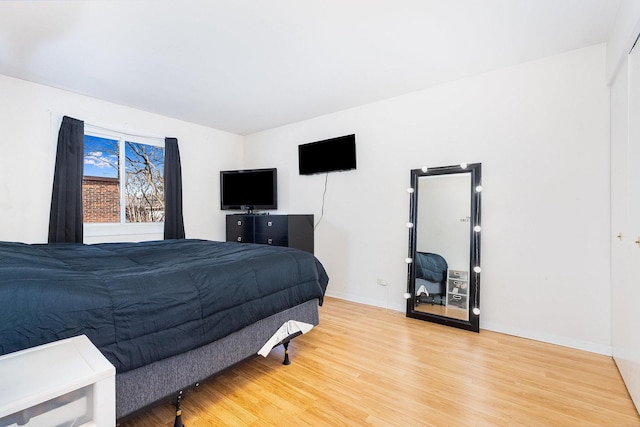 bedroom with baseboards and light wood-type flooring