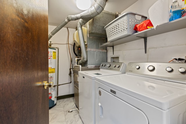 laundry area with laundry area, washer and dryer, gas water heater, and marble finish floor