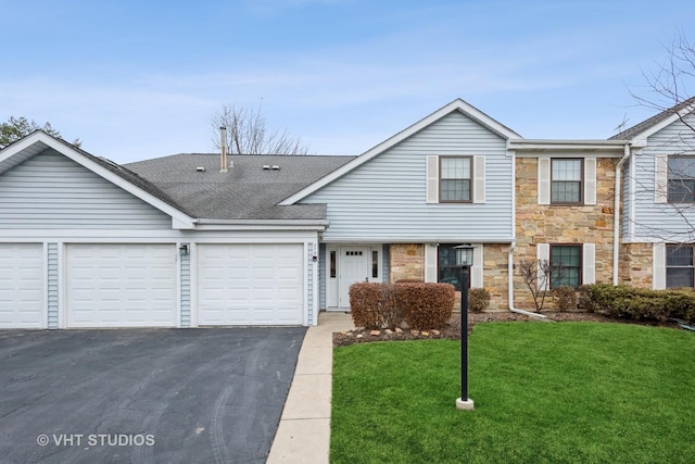 view of front facade with an attached garage, a shingled roof, a front lawn, stone siding, and driveway