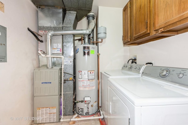 clothes washing area with gas water heater, cabinet space, and separate washer and dryer