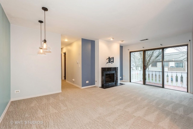 unfurnished living room with light colored carpet, visible vents, a high end fireplace, and baseboards