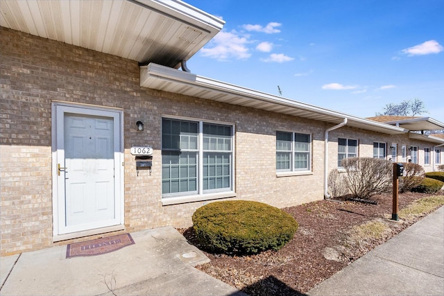 property entrance with brick siding