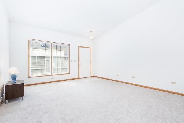 empty room with baseboards and light carpet