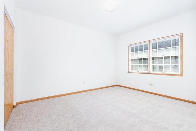 carpeted spare room with baseboards