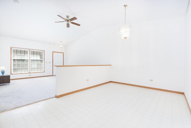 spare room with lofted ceiling, baseboards, and ceiling fan