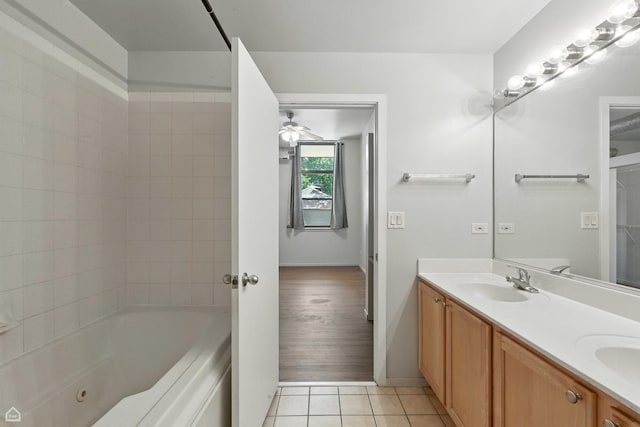 1000 E 53rd St Unit 112, Chicago, IL 60615 - full bath featuring double vanity, tile patterned floors, a ceiling fan, and bathing tub / shower combination