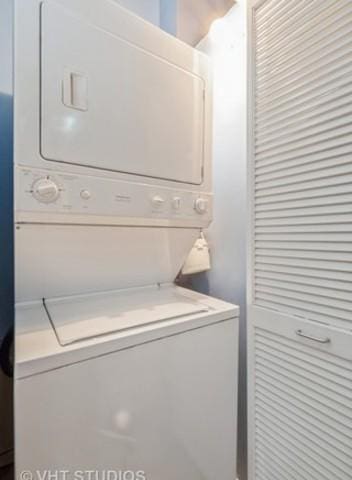 washroom featuring stacked washer and dryer