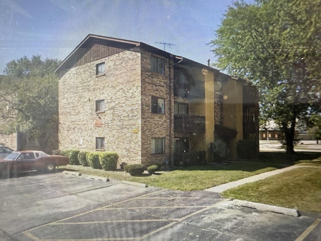 view of property featuring uncovered parking