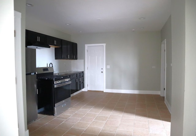 kitchen with baseboards, recessed lighting, light tile patterned flooring, stainless steel appliances, and dark cabinets