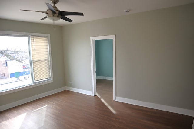 unfurnished room with a ceiling fan, baseboards, and wood finished floors