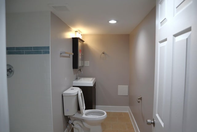 bathroom with vanity, baseboards, visible vents, tile patterned floors, and toilet