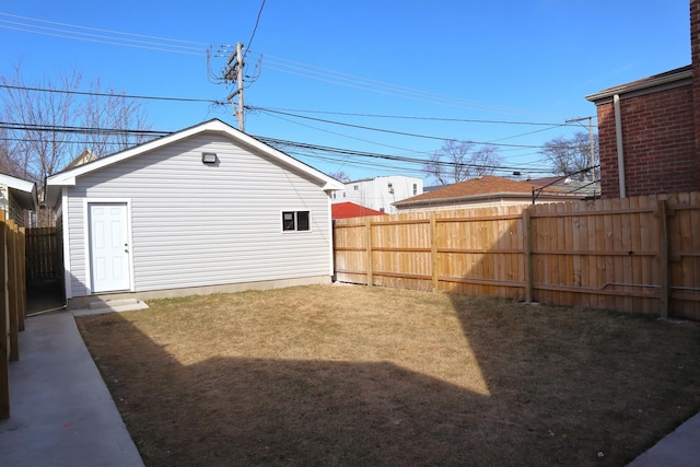 view of yard with an outbuilding and a fenced backyard