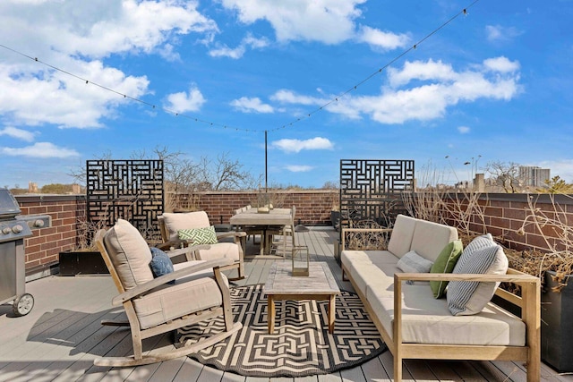 view of patio featuring a deck, an outdoor living space, fence, and area for grilling