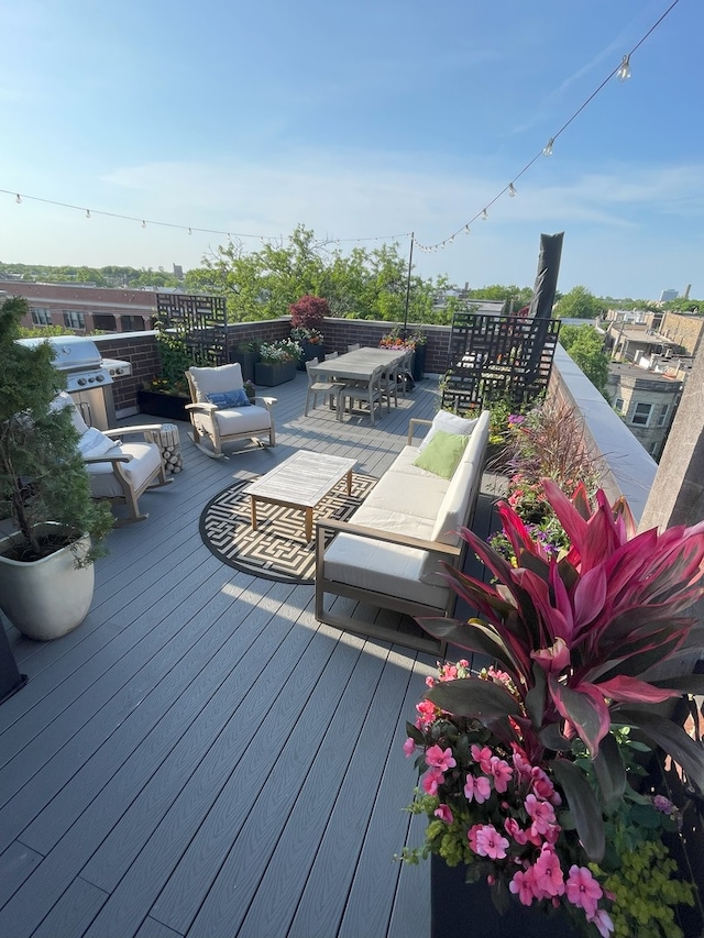 wooden terrace featuring a grill