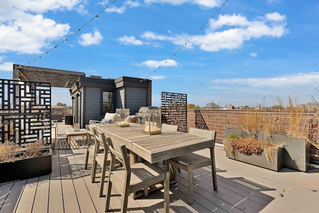 wooden terrace featuring outdoor dining area