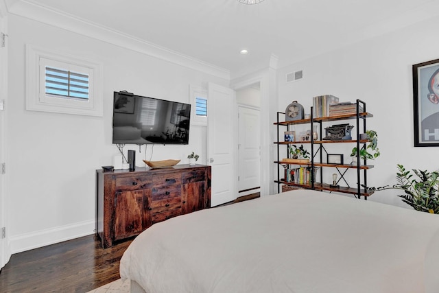 bedroom with visible vents, multiple windows, wood finished floors, and baseboards