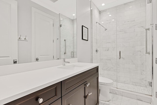 bathroom featuring toilet, marble finish floor, a shower stall, and vanity