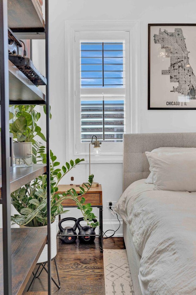bedroom featuring wood finished floors and baseboards