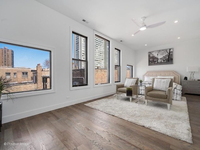 living room with wood finished floors, visible vents, baseboards, recessed lighting, and ceiling fan