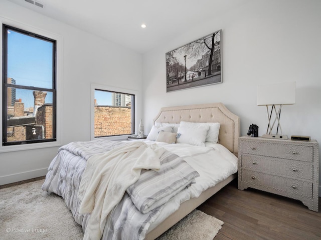 bedroom featuring recessed lighting, wood finished floors, and baseboards