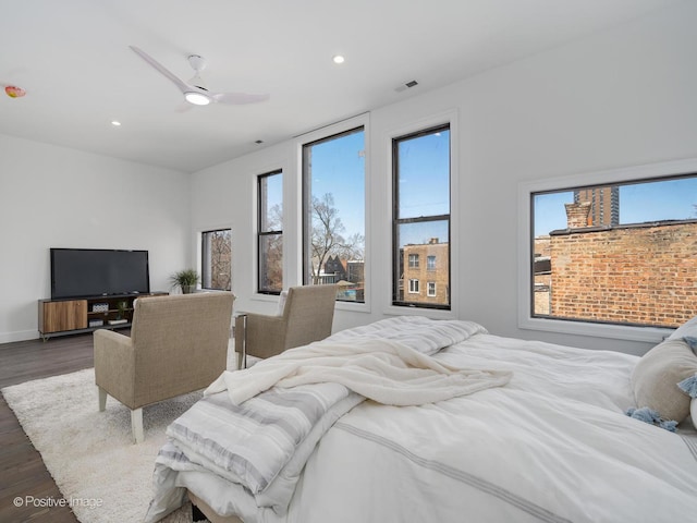 bedroom featuring visible vents, a ceiling fan, wood finished floors, recessed lighting, and baseboards