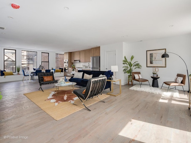 living room with visible vents and light wood finished floors