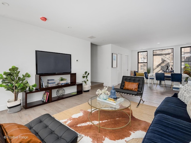 living room featuring baseboards and wood finished floors