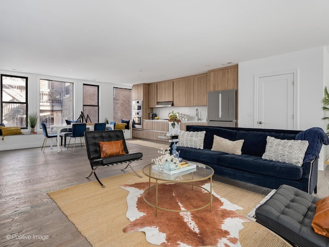 living area with visible vents, baseboards, and light wood-style floors