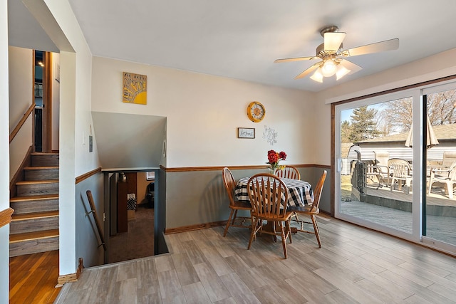 dining room featuring wood finished floors and ceiling fan